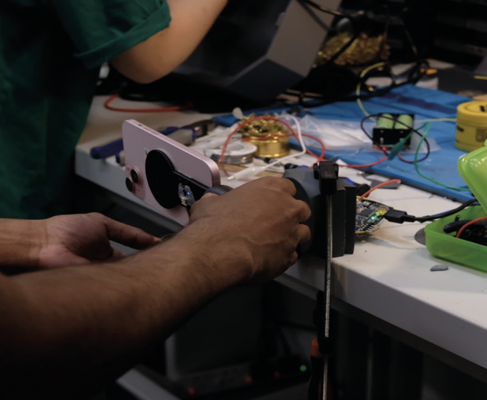 alta arm prototype on the workbench mid-assembly with wiring and dev board